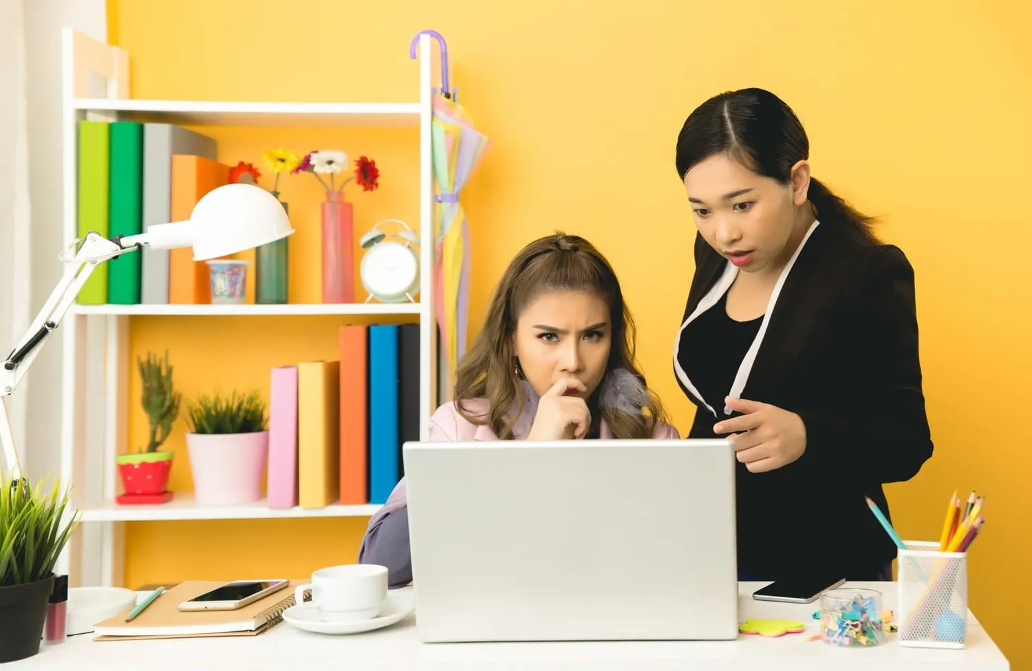 An adult and child using a laptop together